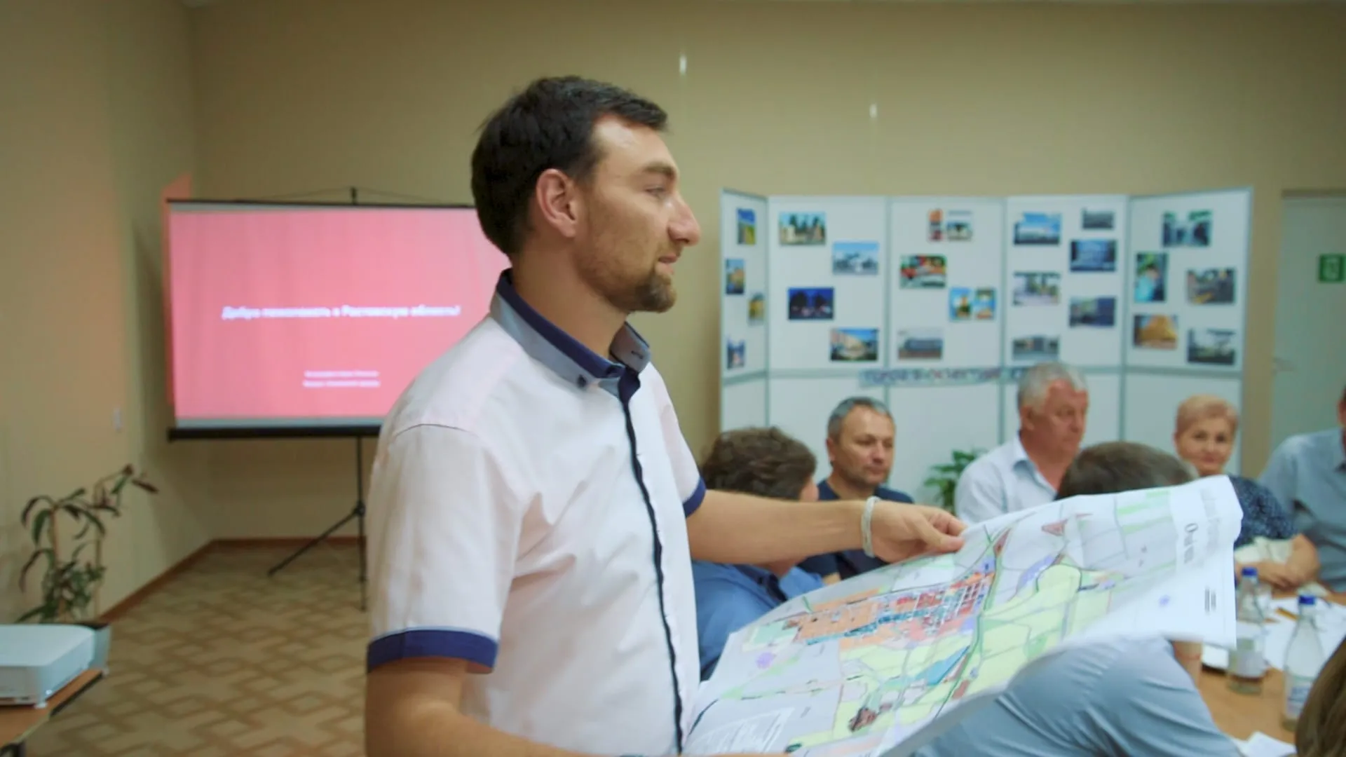 A team member presents a draft map of the town to workshop participants