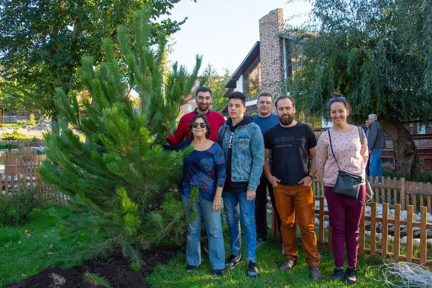 Project partners and guests from Recife next to a newly planted pine tree, 2018