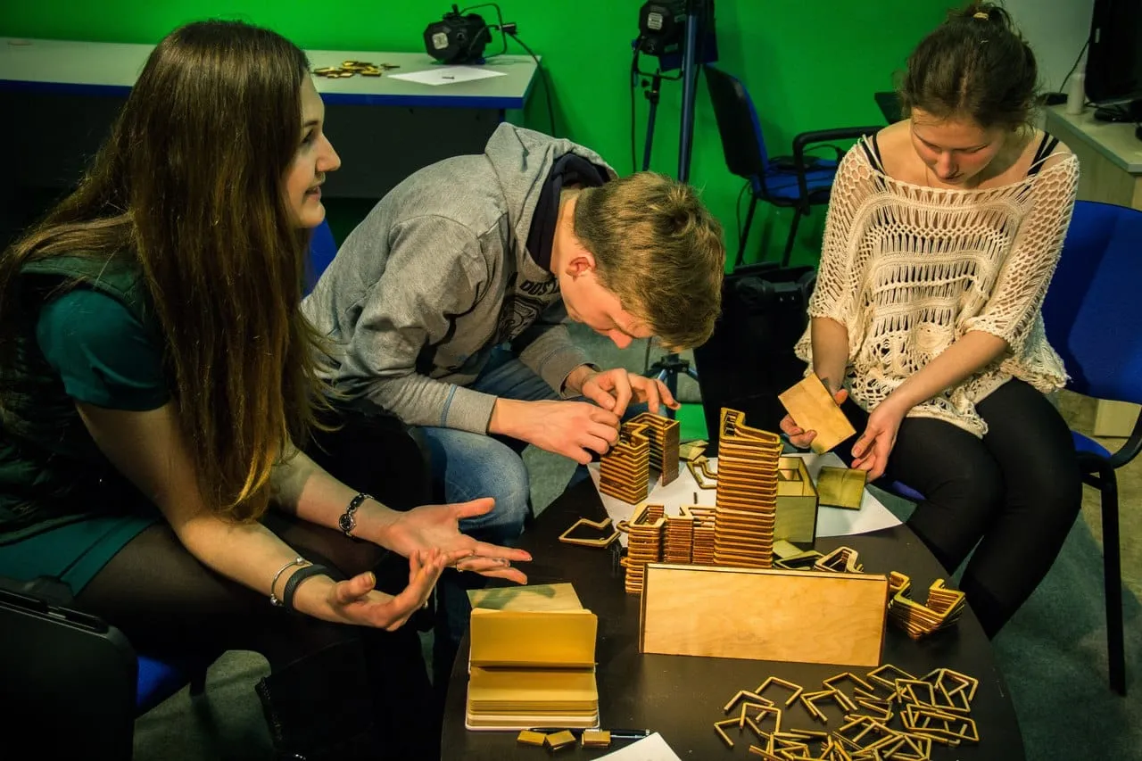 Participants assembling scale models of the micro-park module at a workshop