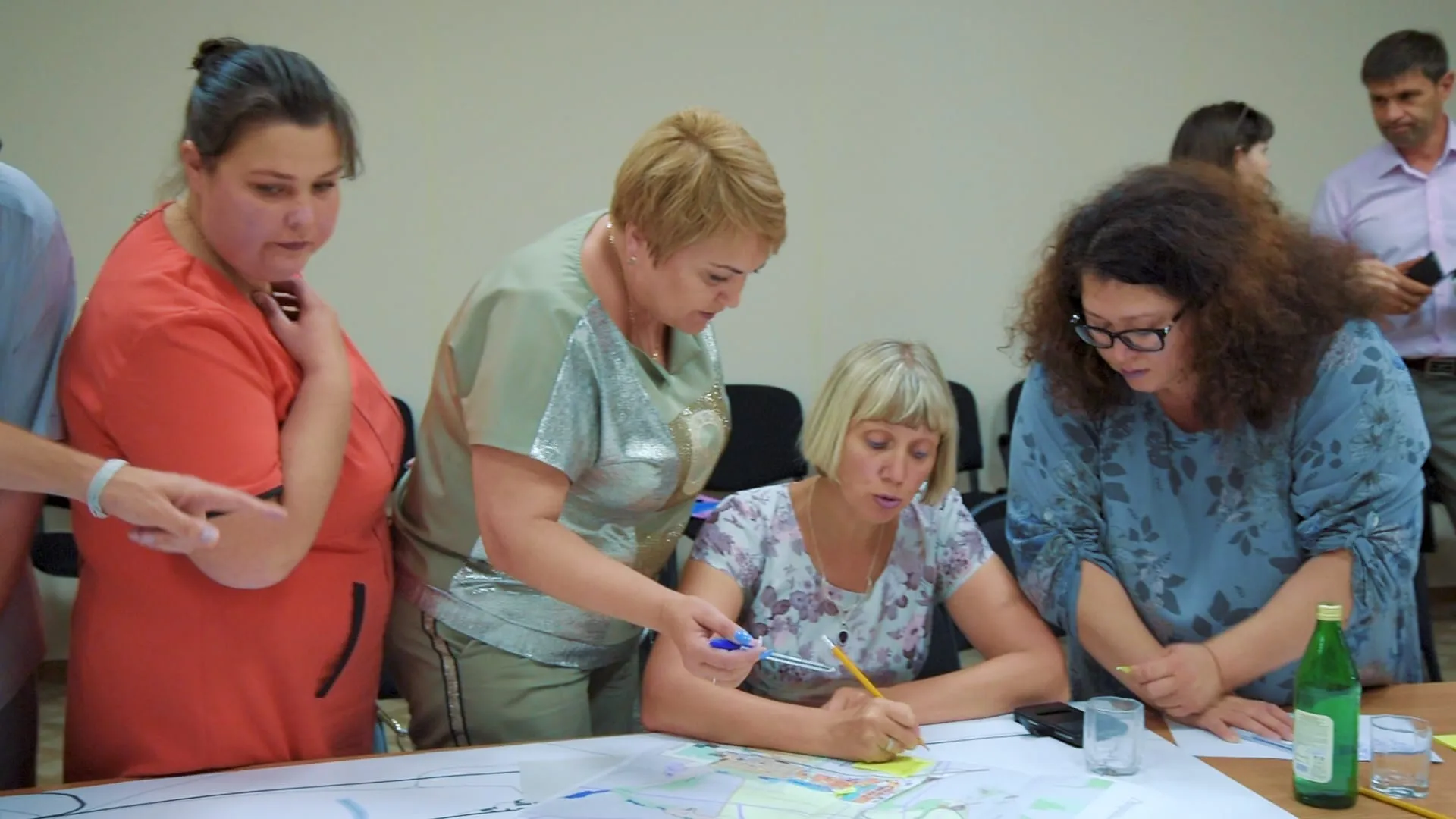 Residents mark ideas with coloured pens and sticky notes on a town plan