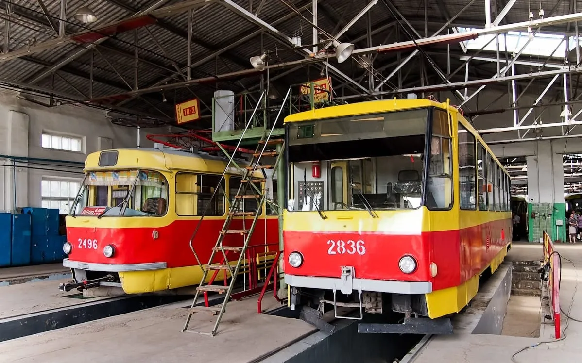 Red and yellow Tatra T3 trams in a depot