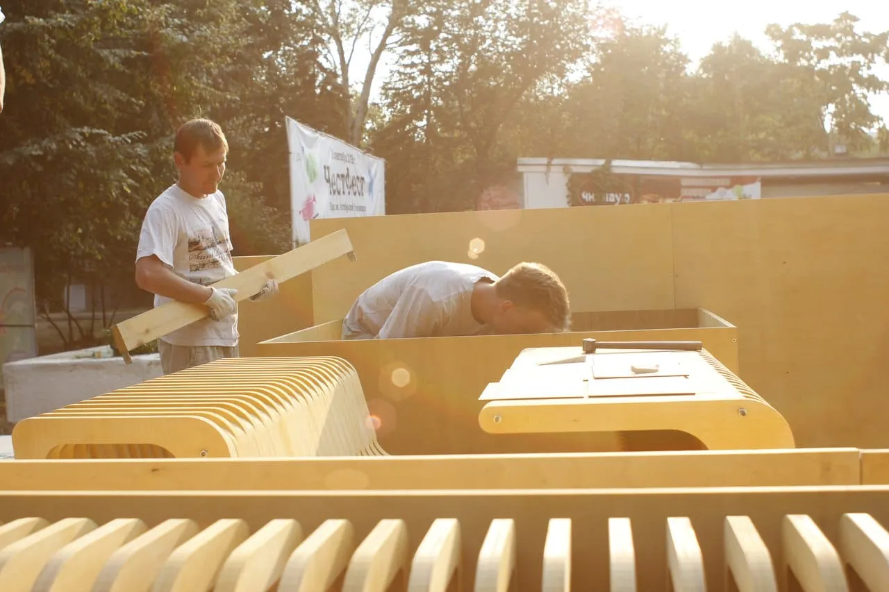 Volunteers assembling the plywood module in the park